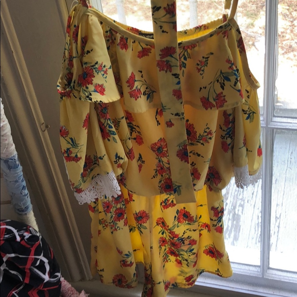 A yellow romper with rose print